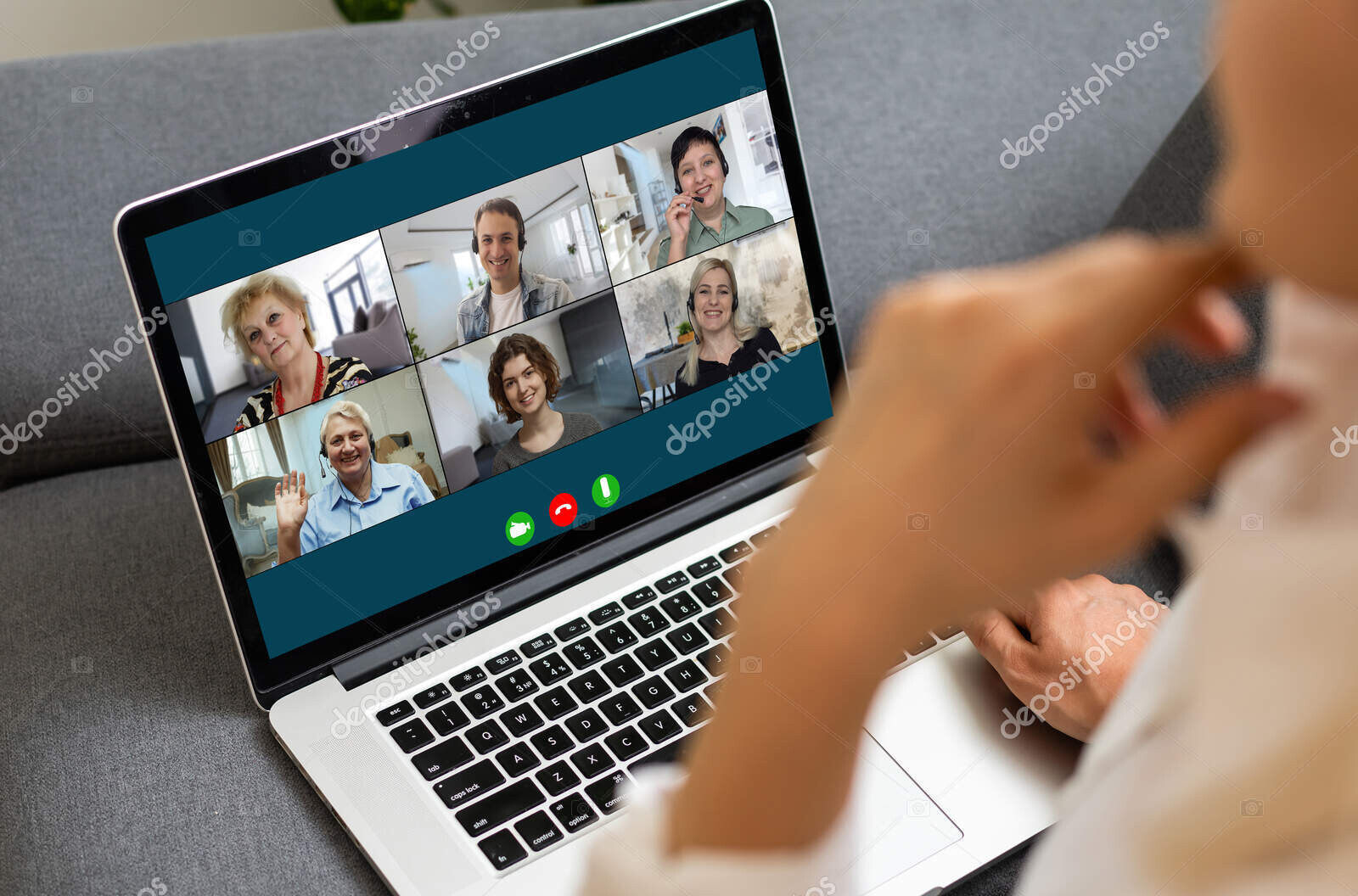 view over businesslady shoulder seated at workplace desk look at computer screen where collage of many diverse people involved at video conference negotiations activity, modern app tech usage concept